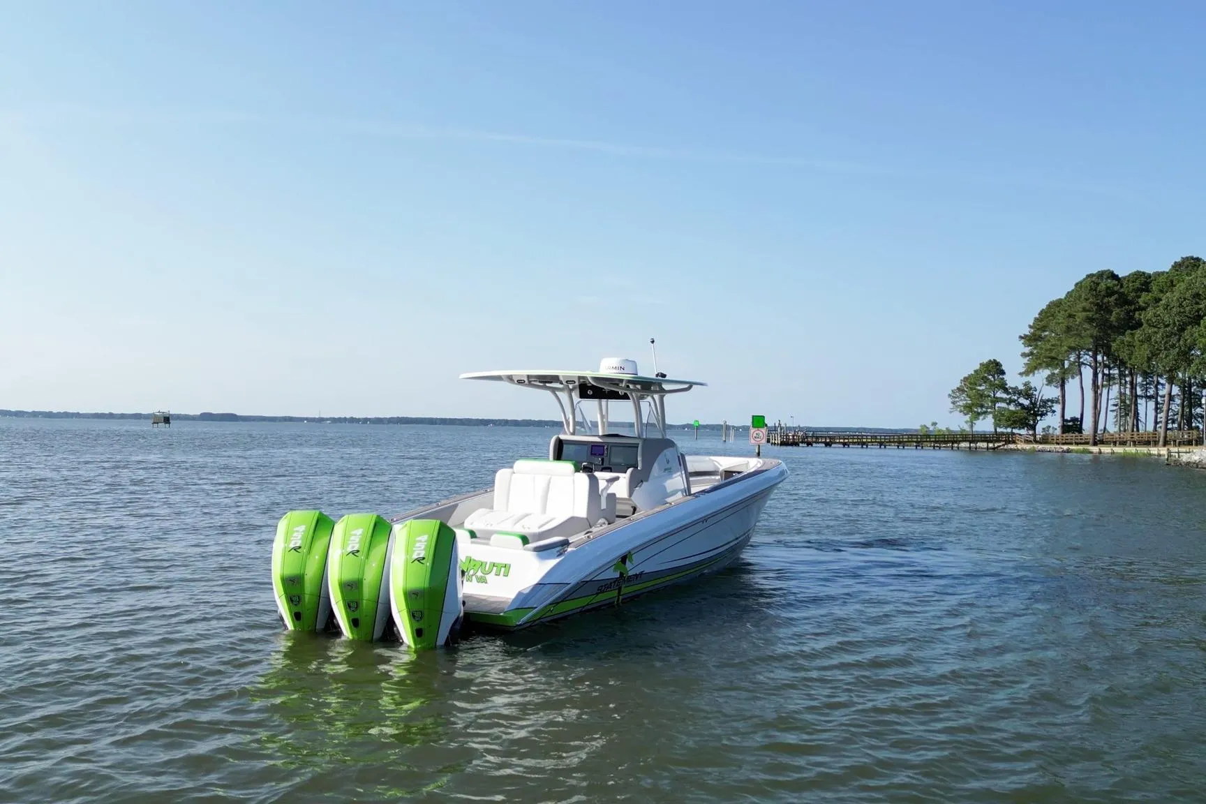 2023 Statement 350 Open boat with triple green outboard motors on calm water.
