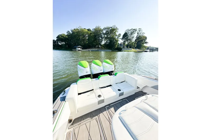  Yacht Photos Pics 2023 Statement 350 Open boat with triple engines on a serene lake.