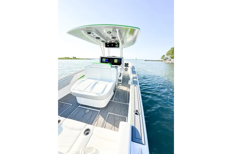 Yacht Photos Pics 2023 Statement 350 Open boat interior with sleek seating and advanced navigation system on calm water.