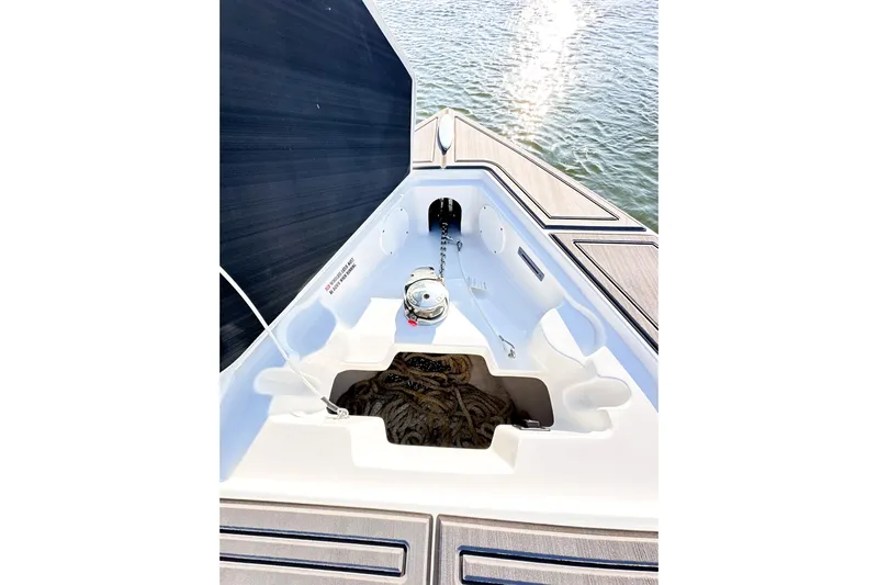  Yacht Photos Pics 2023 Statement 350 Open boat anchor compartment with rope, on calm water.