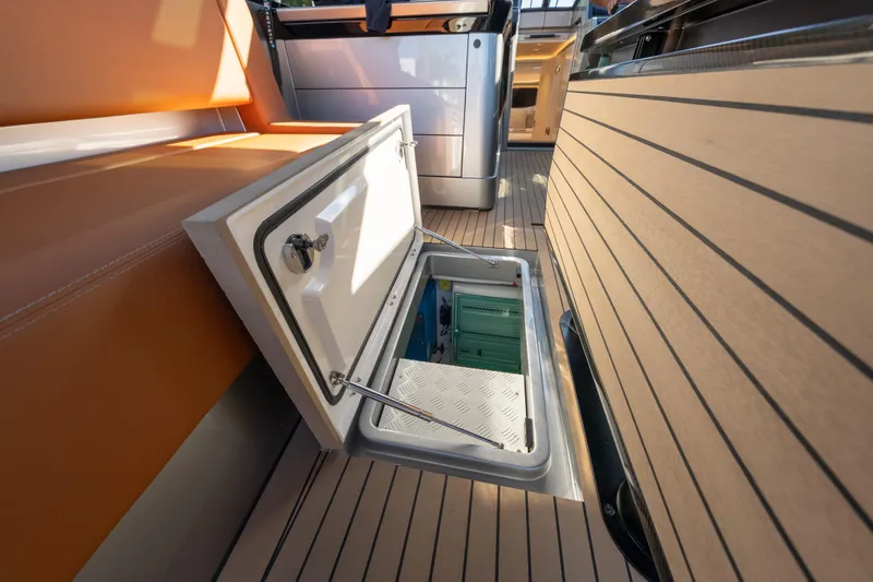 Why Her Yacht Photos Pics Open storage compartment on 2024 Wajer 55 HT yacht deck, showcasing sleek design.
