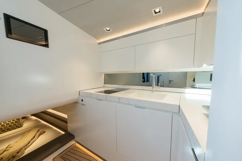 Why Her Yacht Photos Pics Luxurious interior of 2024 Wajer 55 HT yacht with modern white cabinetry and sleek design.