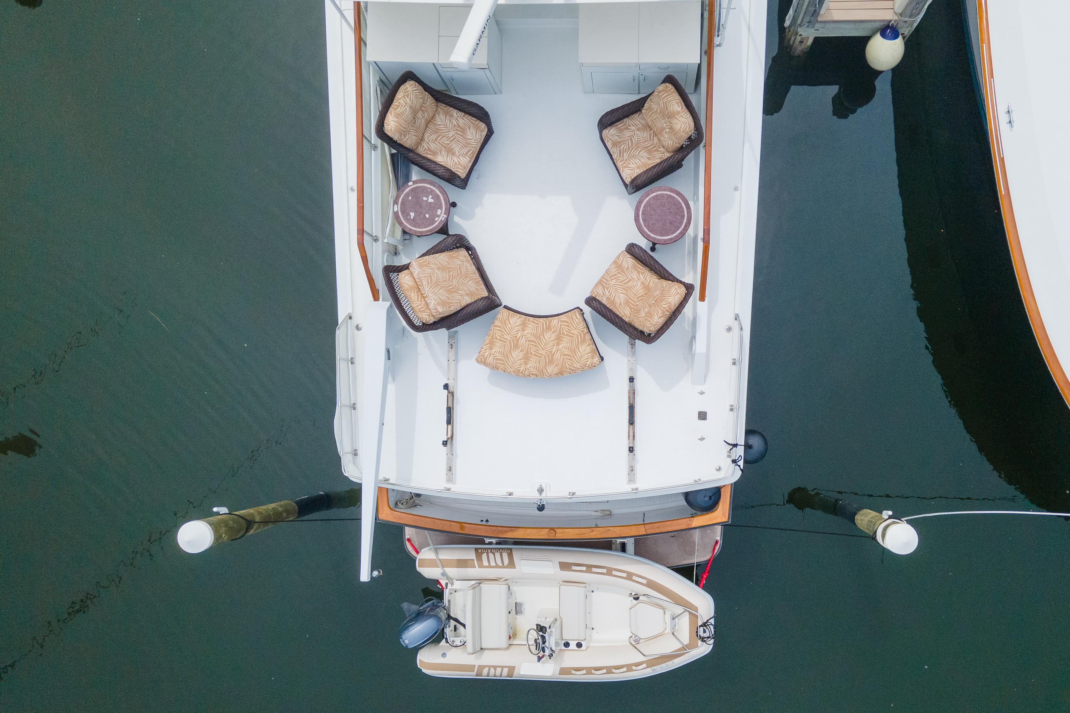 1986 Tollycraft Pilothouse boat with outdoor seating, docked aerial view.