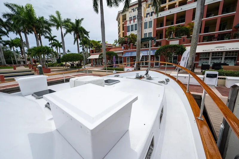 Motivated Seller Yacht Photos Pics 1986 Tollycraft Pilothouse yacht docked near palm trees and buildings.