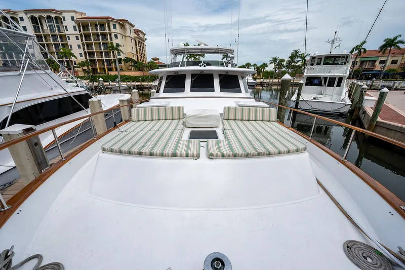 Motivated Seller Yacht Photos Pics 1986 Tollycraft Pilothouse yacht docked with striped sun pads on the bow.