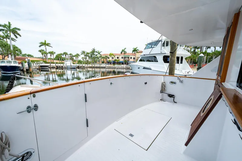 Motivated Seller Yacht Photos Pics 1986 Tollycraft Pilothouse yacht deck with marina view and palm trees.