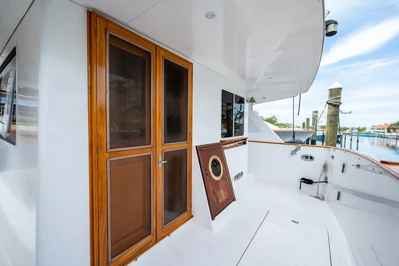 Motivated Seller Yacht Photos Pics 1986 Tollycraft Pilothouse yacht deck with wooden doors and marina view.
