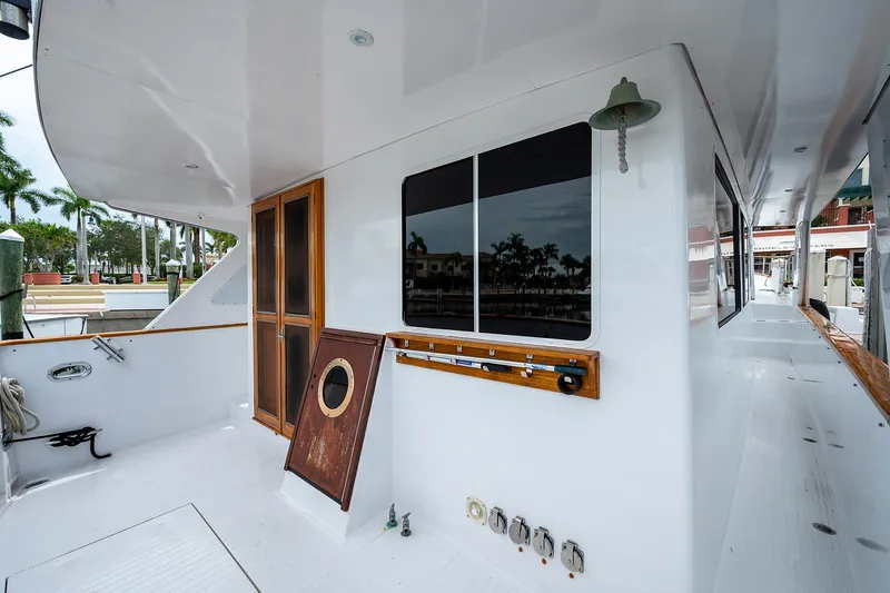 Motivated Seller Yacht Photos Pics 1986 Tollycraft Pilothouse yacht deck with wooden accents and dockside view.