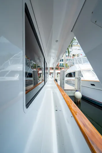 Motivated Seller Yacht Photos Pics 1986 Tollycraft Pilothouse yacht docked, side deck view with wooden railings.