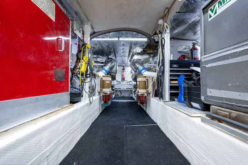 Motivated Seller Yacht Photos Pics Engine room of a 1986 Tollycraft Pilothouse yacht with equipment and machinery.