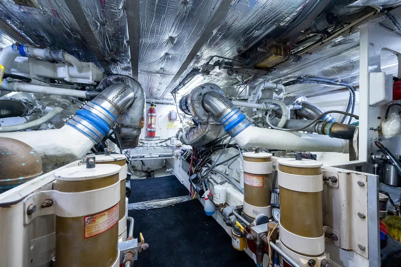 Motivated Seller Yacht Photos Pics Engine room of a 1986 Tollycraft Pilothouse yacht with visible machinery and equipment.