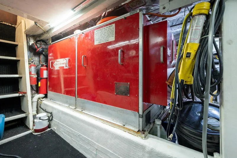 Motivated Seller Yacht Photos Pics 1986 Tollycraft Pilothouse engine room with red generator and safety equipment.