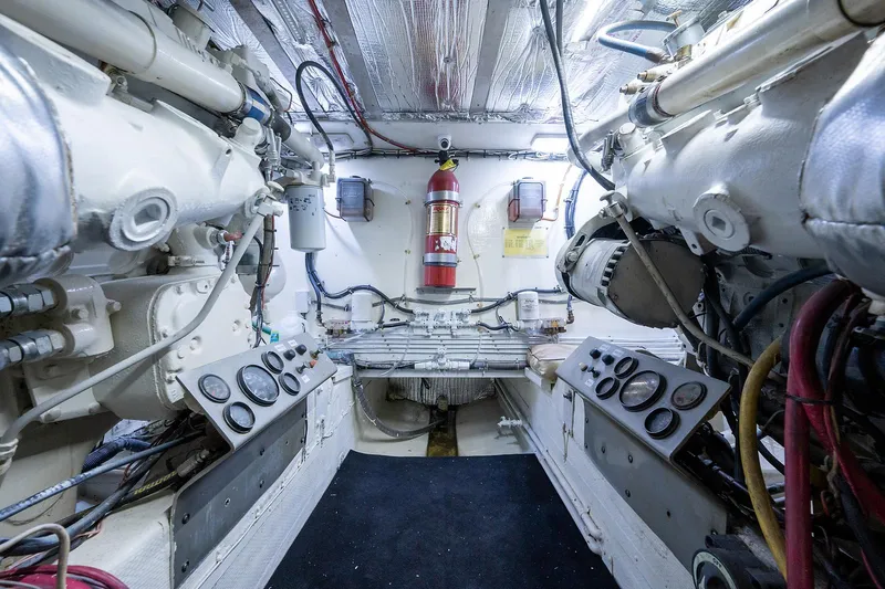 Motivated Seller Yacht Photos Pics Engine room of a 1986 Tollycraft Pilothouse yacht with dual engines and fire extinguisher.