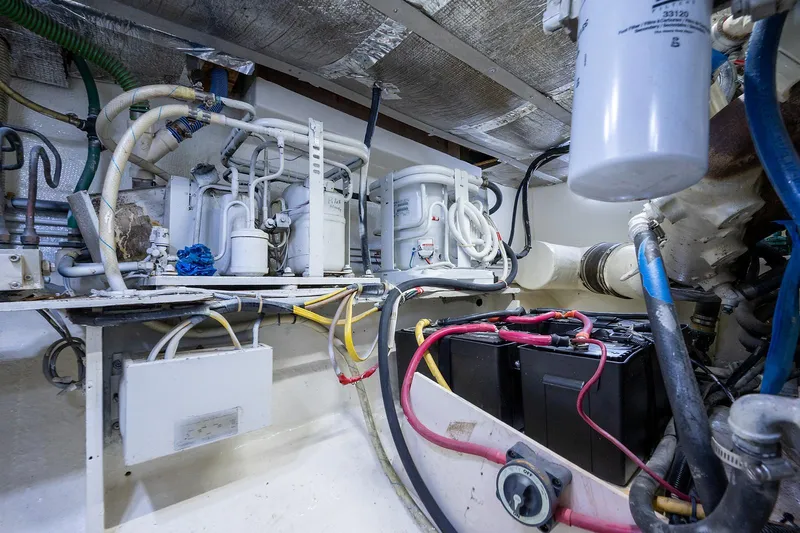 Motivated Seller Yacht Photos Pics 1986 Tollycraft Pilothouse engine room with batteries and mechanical components.