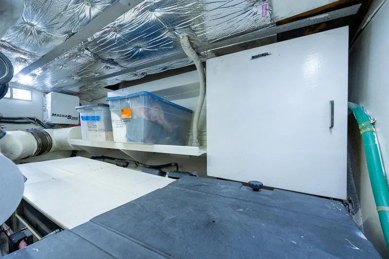 Motivated Seller Yacht Photos Pics 1986 Tollycraft Pilothouse engine room with storage containers and insulated ceiling.