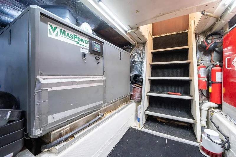 Motivated Seller Yacht Photos Pics Engine room of a 1986 Tollycraft Pilothouse with MasPower generator and stairs.