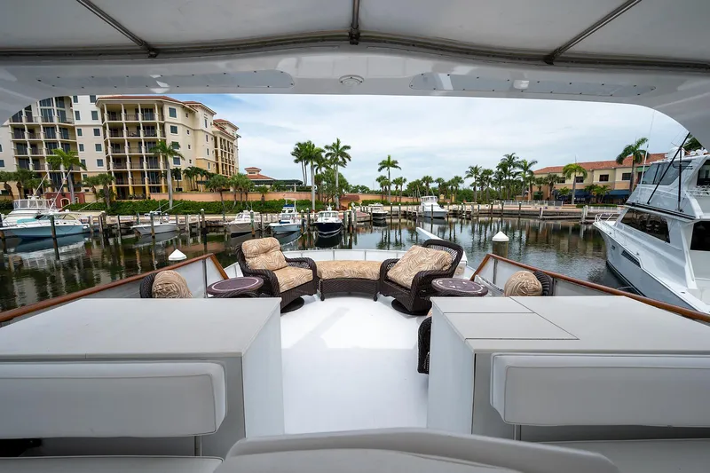 Motivated Seller Yacht Photos Pics 1986 Tollycraft Pilothouse yacht with luxurious outdoor seating in a marina.