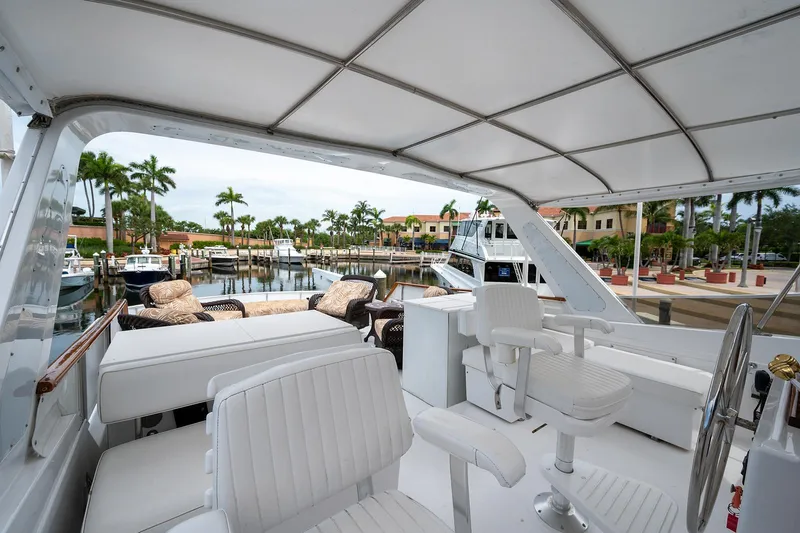 Motivated Seller Yacht Photos Pics 1986 Tollycraft Pilothouse yacht interior with white seating at a marina.