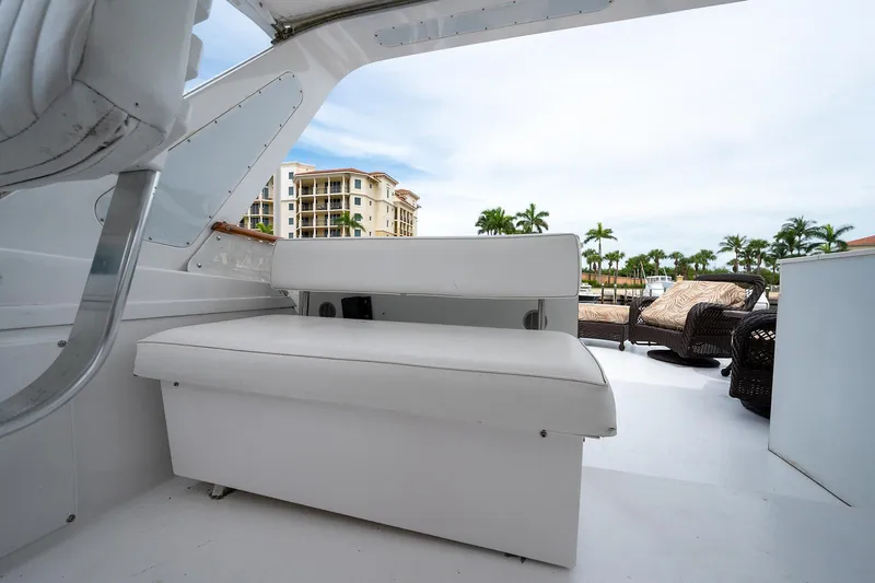 Motivated Seller Yacht Photos Pics 1986 Tollycraft Pilothouse boat interior with white seating, coastal view in background.