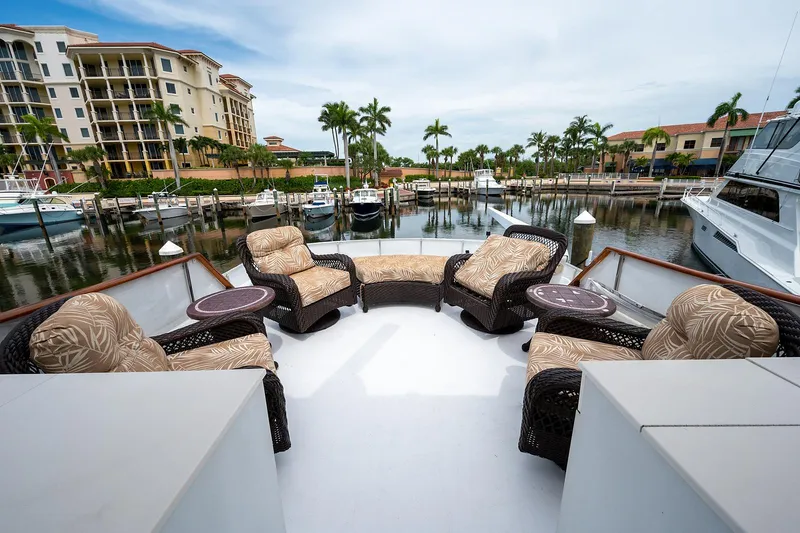 Motivated Seller Yacht Photos Pics 1986 Tollycraft Pilothouse yacht with outdoor seating area in a marina.