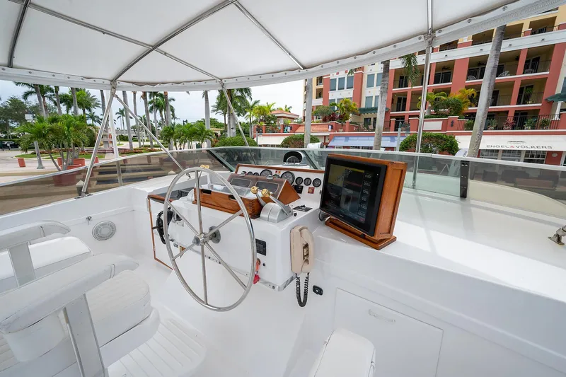 Motivated Seller Yacht Photos Pics 1986 Tollycraft Pilothouse boat helm with steering wheel and navigation equipment.