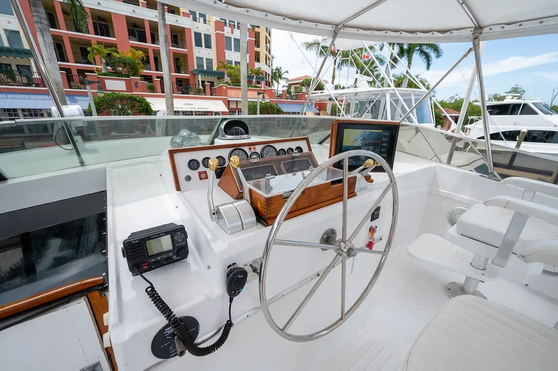 Motivated Seller Yacht Photos Pics 1986 Tollycraft Pilothouse helm with steering wheel and navigation instruments.