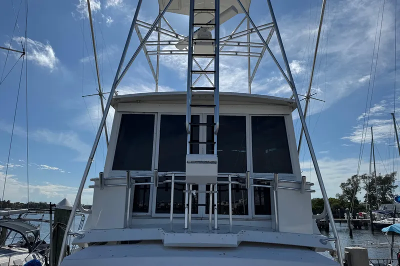  Yacht Photos Pics 1995 Viking 58 Convertible yacht with tower, docked under a clear blue sky.