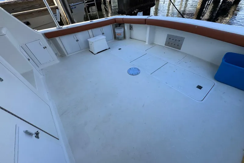  Yacht Photos Pics Spacious deck of a 1995 Viking 58 Convertible boat, featuring storage compartments and seating.