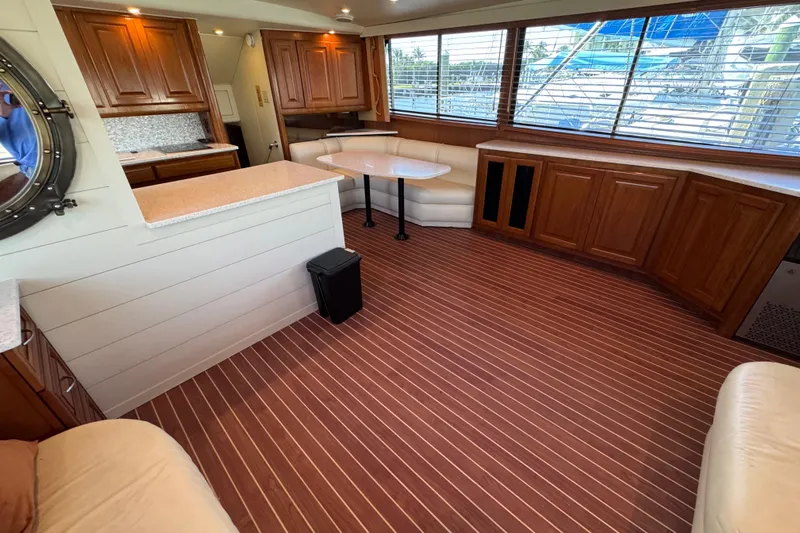  Yacht Photos Pics Luxurious interior of 1995 Viking 58 Convertible yacht with wood accents and spacious seating.