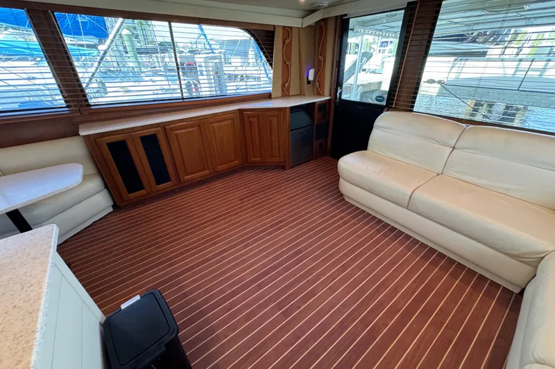  Yacht Photos Pics Interior of 1995 Viking 58 Convertible yacht with leather seating and wood cabinetry.