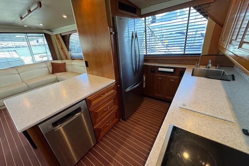  Yacht Photos Pics Luxurious kitchen interior of a 1995 Viking 58 Convertible yacht with modern appliances.