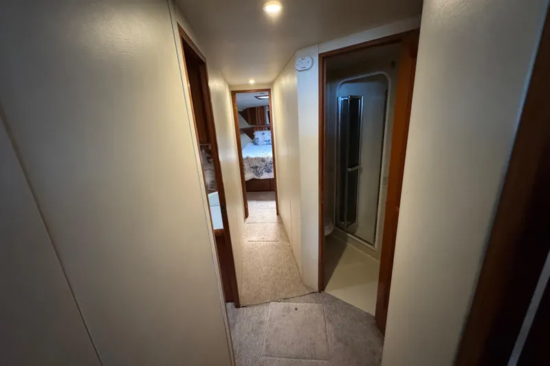  Yacht Photos Pics Hallway inside 1995 Viking 58 Convertible yacht, featuring bedroom and bathroom access.