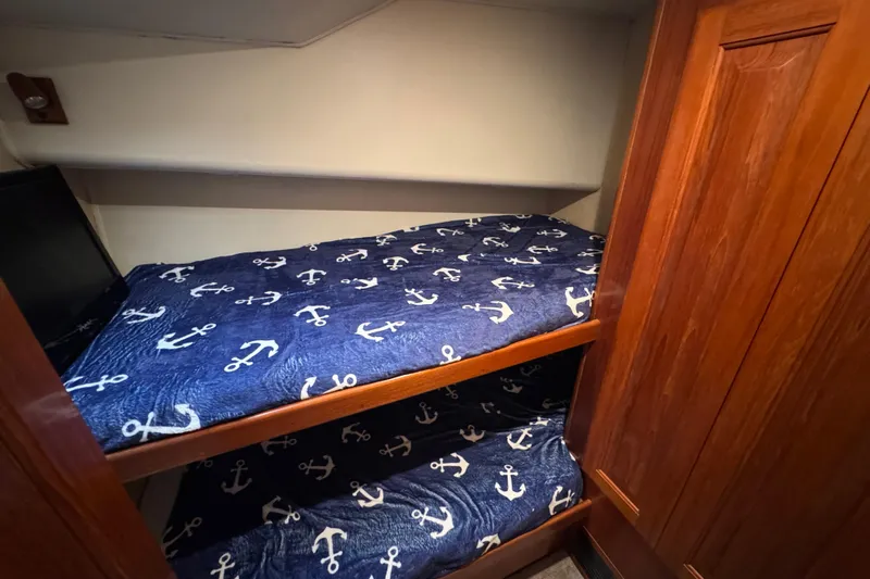  Yacht Photos Pics Bunk beds with anchor-themed bedding in 1995 Viking 58 Convertible yacht cabin.
