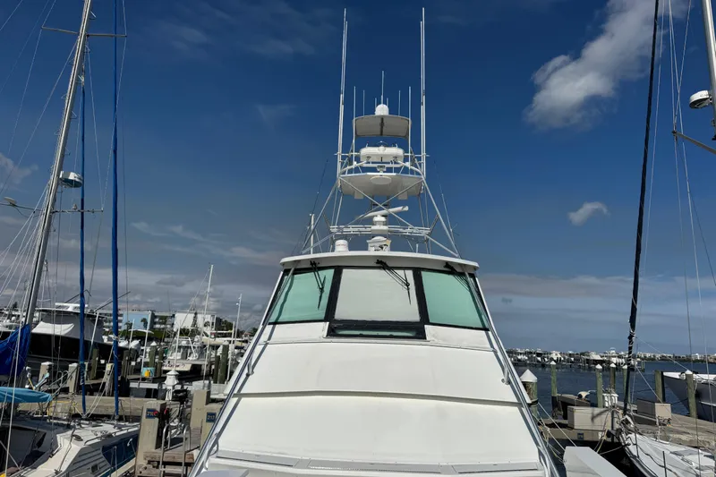  Yacht Photos Pics 1995 Viking 58 Convertible yacht docked at marina under clear blue sky.