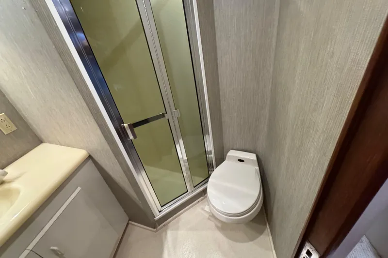  Yacht Photos Pics Bathroom interior of 1995 Viking 58 Convertible yacht with shower and toilet.