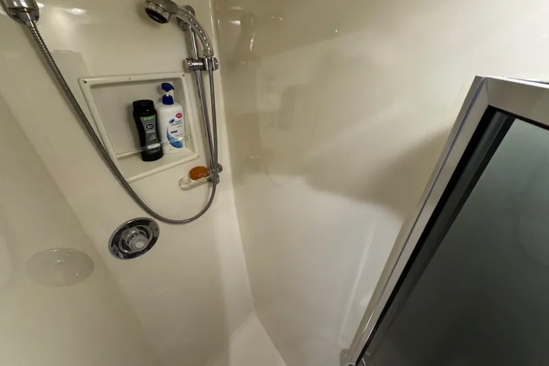  Yacht Photos Pics Shower area in 1995 Viking 58 Convertible yacht with toiletries and chrome fixtures.