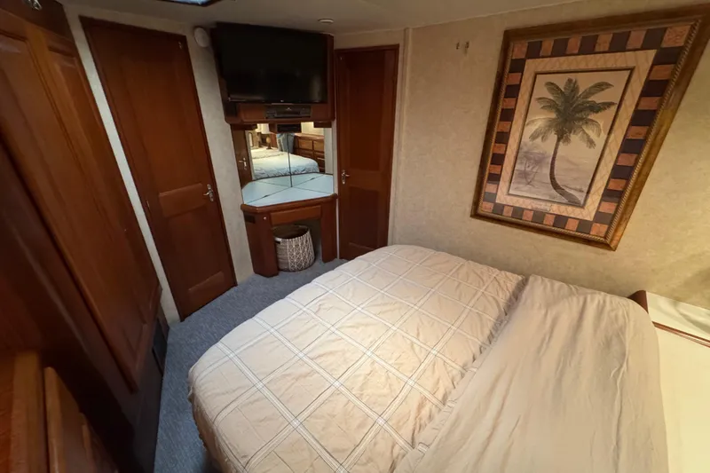  Yacht Photos Pics Cozy bedroom in 1995 Viking 58 Convertible yacht with palm tree artwork.