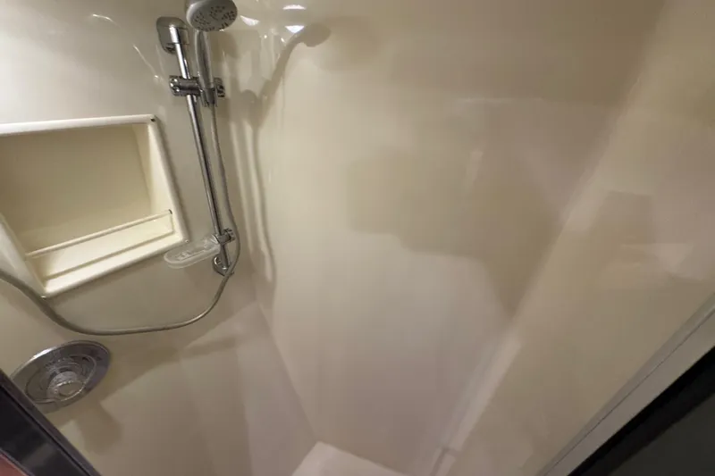  Yacht Photos Pics Shower area in 1995 Viking 58 Convertible yacht, featuring chrome fixtures and built-in shelf.