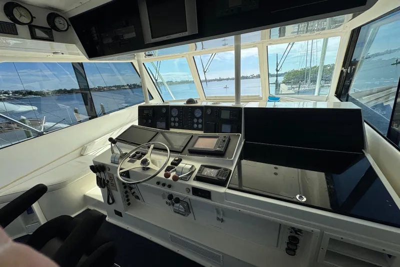  Yacht Photos Pics Cockpit of 1995 Viking 58 Convertible yacht with navigation instruments and scenic water view.