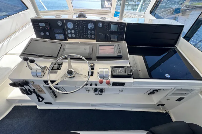  Yacht Photos Pics Cockpit of 1995 Viking 58 Convertible yacht with steering wheel and navigation instruments.