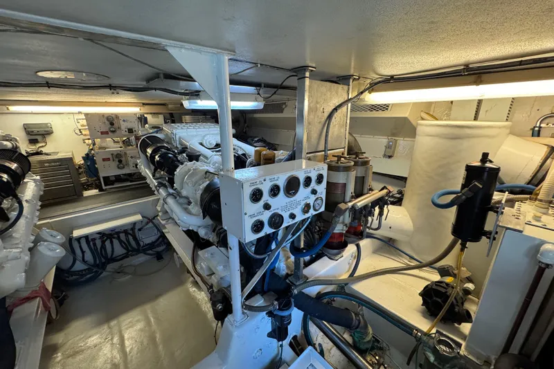  Yacht Photos Pics Engine room of a 1995 Viking 58 Convertible yacht, showcasing machinery and control panels.