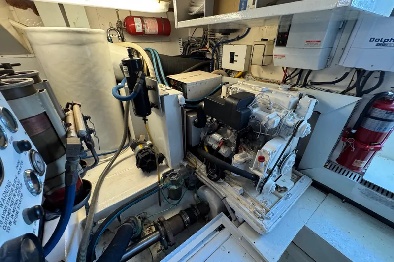  Yacht Photos Pics Engine room of 1995 Viking 58 Convertible yacht with visible machinery and fire extinguisher.