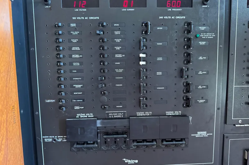  Yacht Photos Pics Electrical panel of a 1995 Viking 58 Convertible boat, showing various circuit controls.