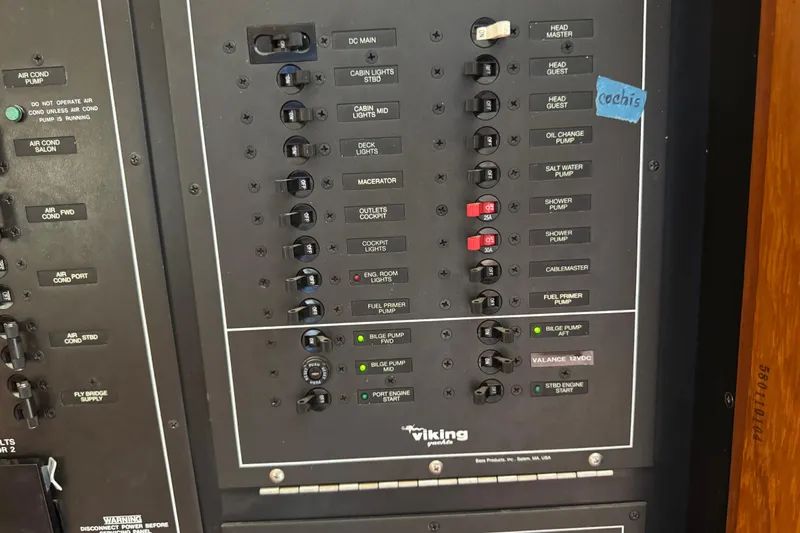 Yacht Photos Pics Control panel of a 1995 Viking 58 Convertible yacht with various switches and labels.