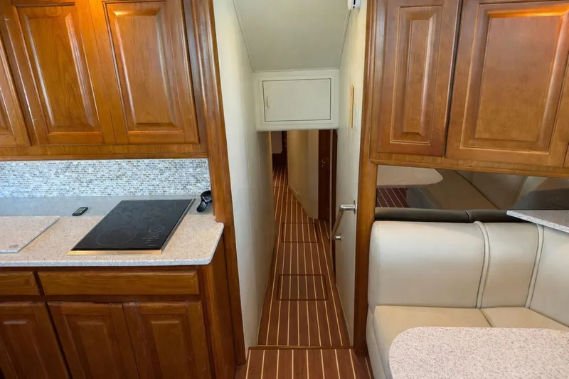  Yacht Photos Pics Interior of 1995 Viking 58 Convertible yacht with wooden cabinets and modern kitchen.
