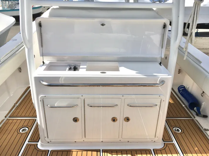  Yacht Photos Pics 2020 Southport 33 FE boat interior with white cabinetry and teak flooring.
