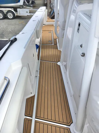  Yacht Photos Pics 2020 Southport 33 FE boat deck with teak flooring and white interior.