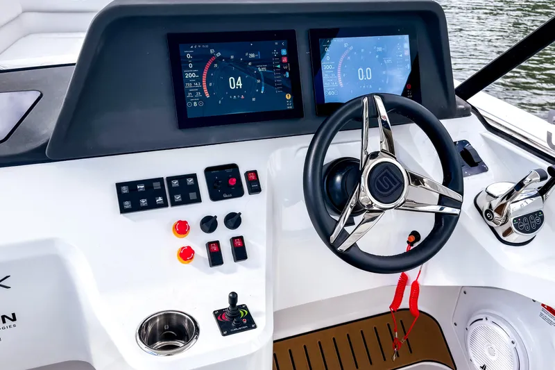  Yacht Photos Pics Modern STERK 31 boat dashboard with dual screens and sleek steering wheel, 2025 model.