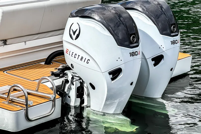  Yacht Photos Pics Twin electric outboard motors on a 2025 STERK 31 boat, docked on water.