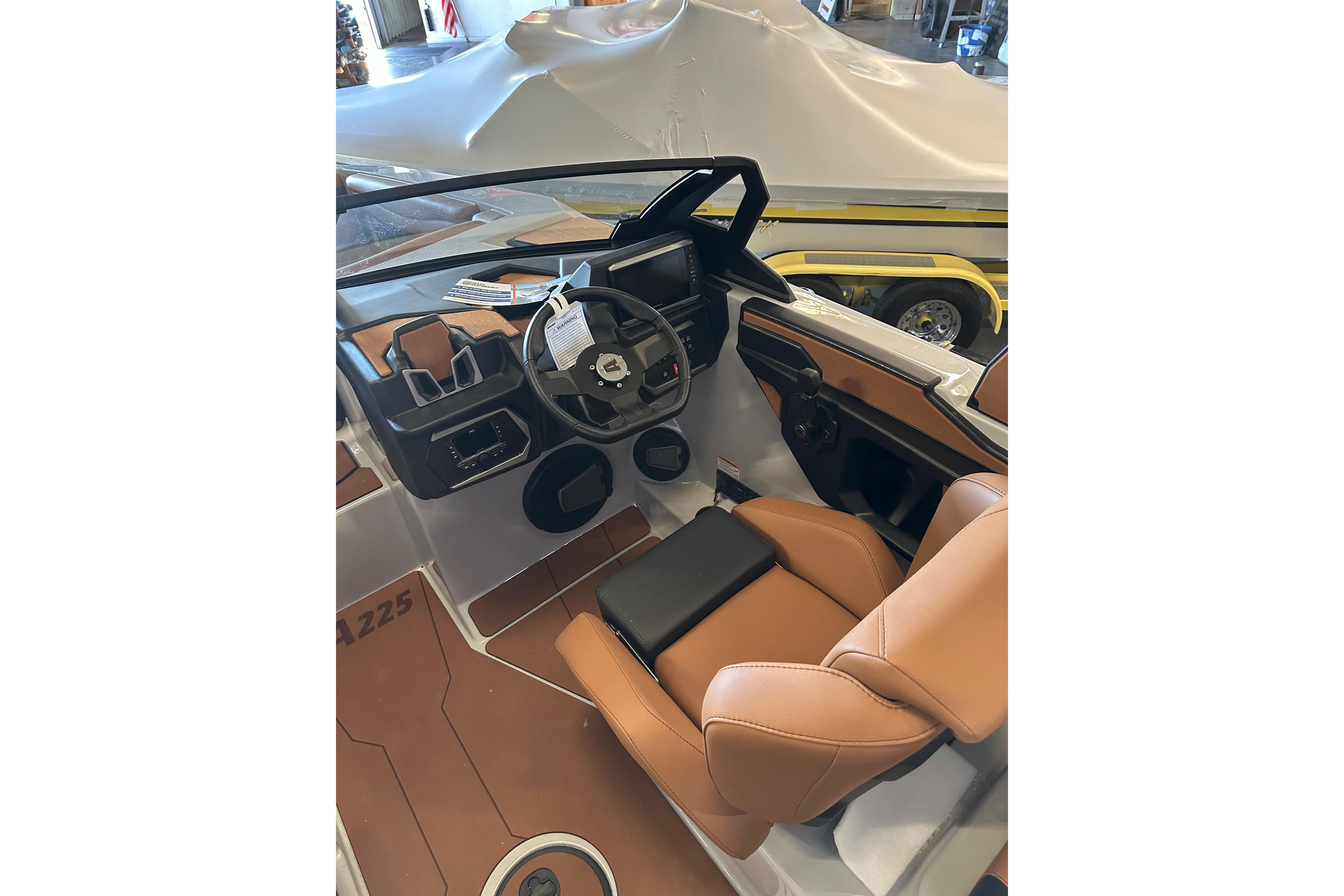 2026 Axis A225 boat interior with tan leather seats and modern dashboard.